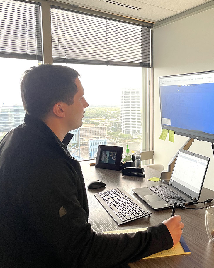 Services Pg - Audit - Service Offerings - Agreed Upon - FL Office - April 2021 - Male Working At Standing Desk 2